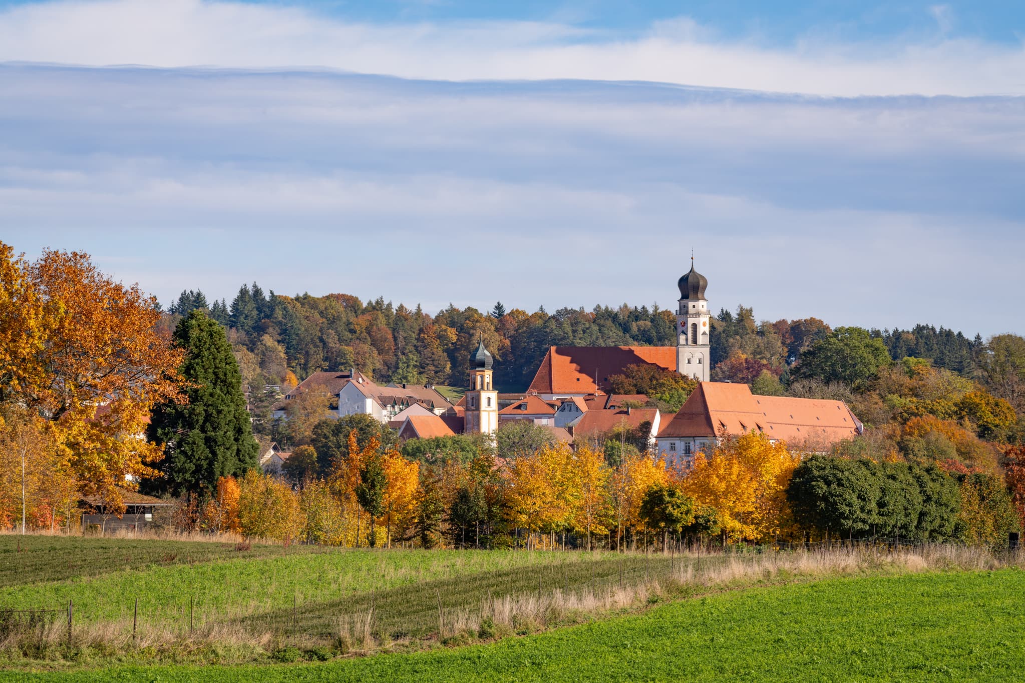 Herbstliche Stadtansicht von Bad Griesbach im Rottal, einem Kurort im Landkreis Passau, Niederbayern. Farbenprächtige Bäume umrahmen die Stadtansicht.