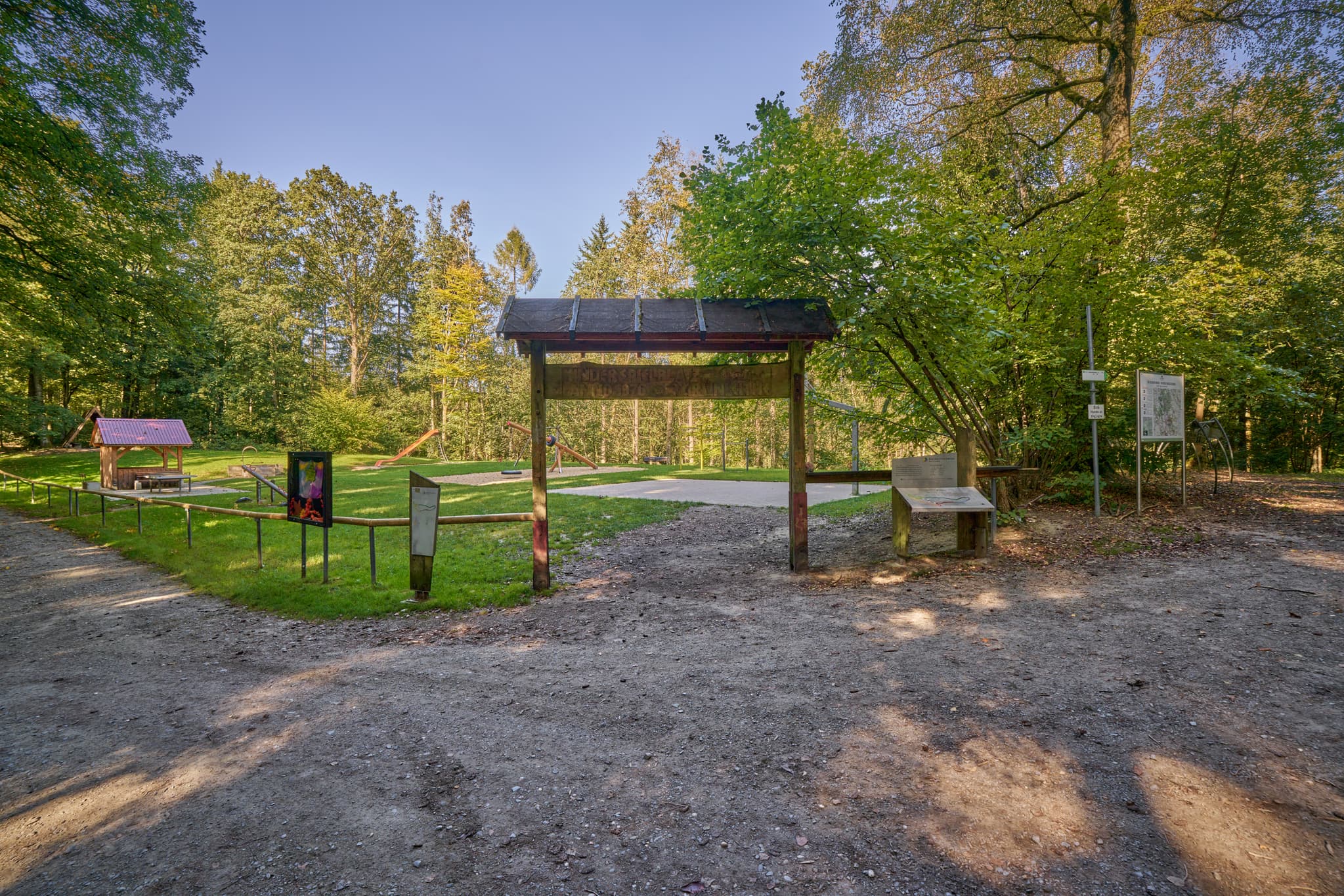 Spielplatz in Bad Griesbach, Passau, Niederbayern. Blick durch Holzkonstruktion auf Grünfläche mit Spielgeräten. Niederbayern, Bayern, Deutschland.