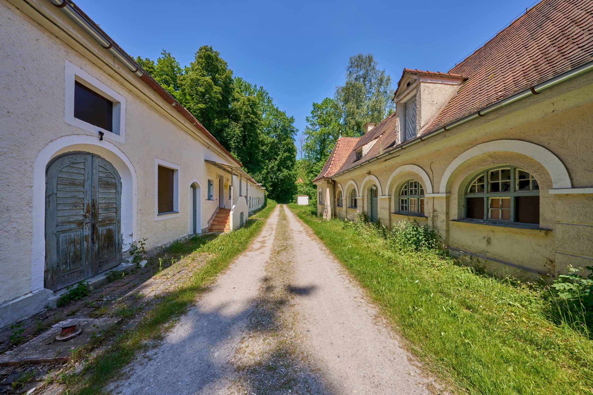 Alte Wäscherei in Ecksberg, Mühldorf am Inn, Oberbayern, Inn-Salzach, Deutschland. Historische Gebäude an einem Schotterweg.