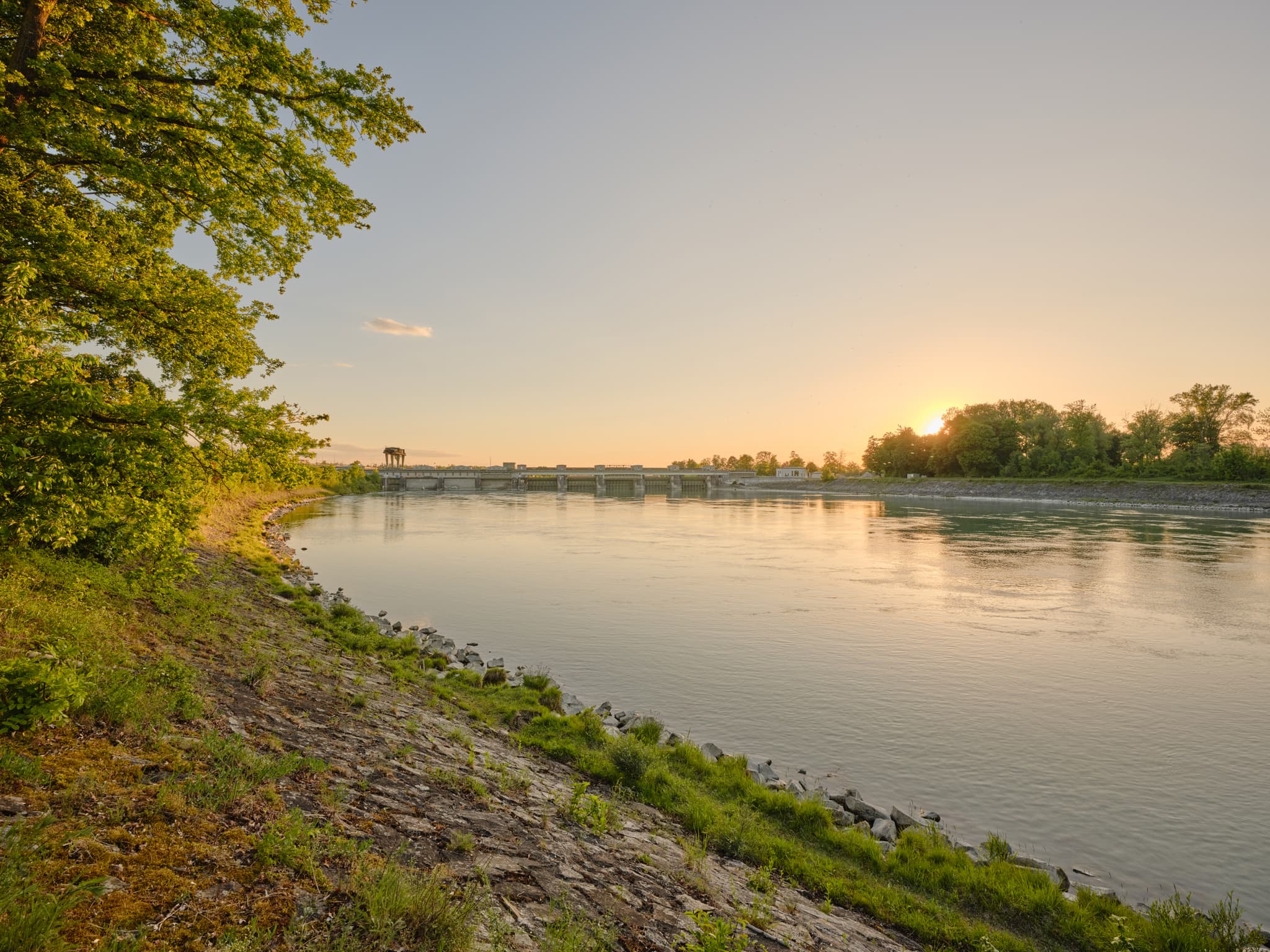 Inn Staustufe des Verbund in Neuötting, Landkreis Altötting, Oberbayern, Deutschland. Flusslandschaft der Inn-Salzach Region im Abendlicht.