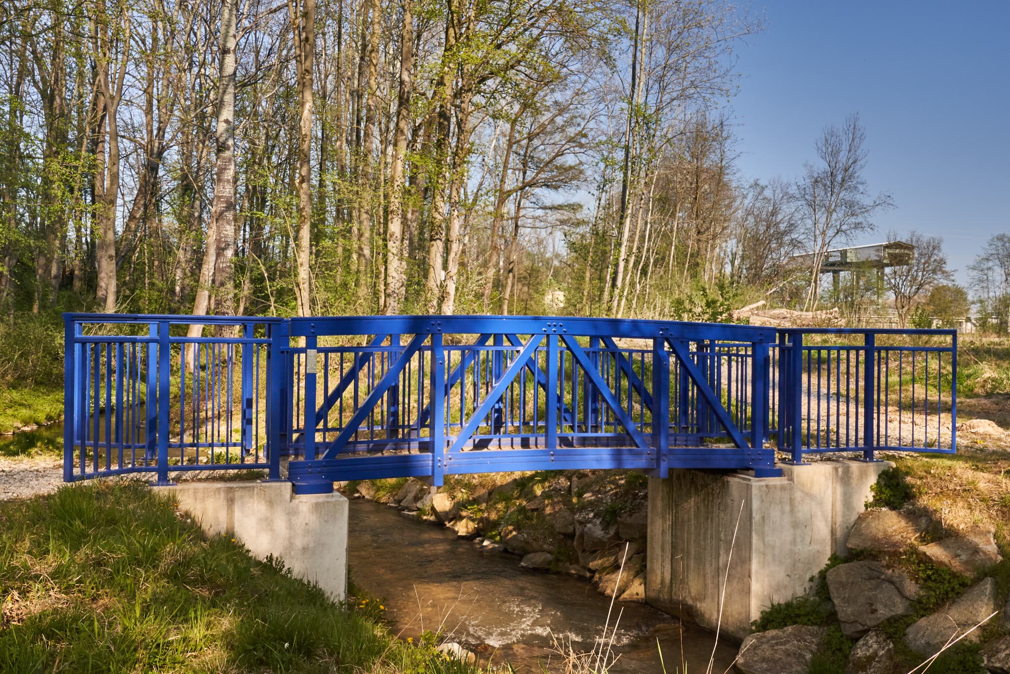 Blaue Brücke der Fischtreppe am Inn Kraftwerk in Stammham, Altötting, Oberbayern, Deutschland. Überquert ein Gewässer, umgeben von Natur der Inn-Salzach Region.