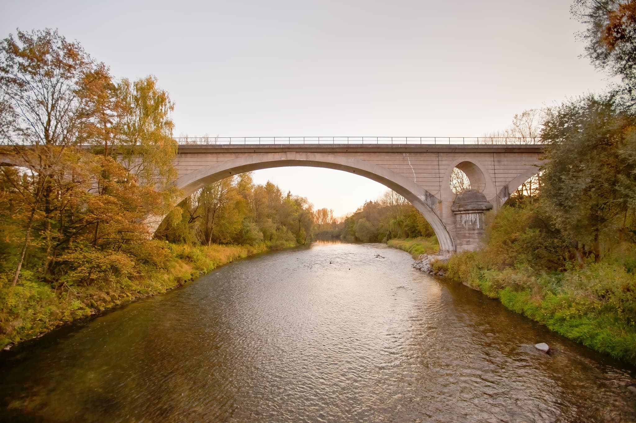 Bahnbrücke überspannt die Alz bei Garching, Landkreis Altötting, Oberbayern. Herbstliche Landschaft der Region Inn-Salzach in Deutschland.