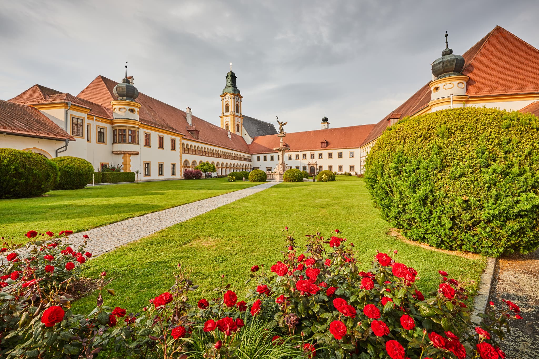 Das Augustiner-Chorherrenstift Reichersberg, ein Barockbau mit Kirchturm und gepflegtem Innenhof, liegt in Reichersberg, Ried, Oberösterreich, Österreich.