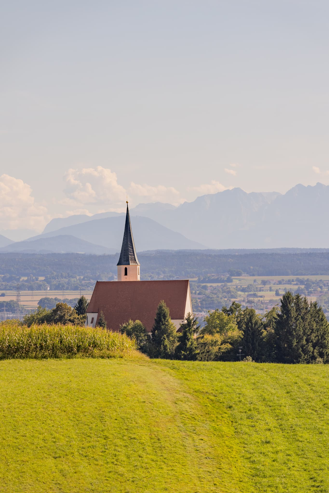 Pfarrkirche St. Georg und Urban in Stubenberg, Rottal-Inn, Niederbayern. Kirche mit weitem Alpenblick und Bergpanorama, Holzland, Deutschland.