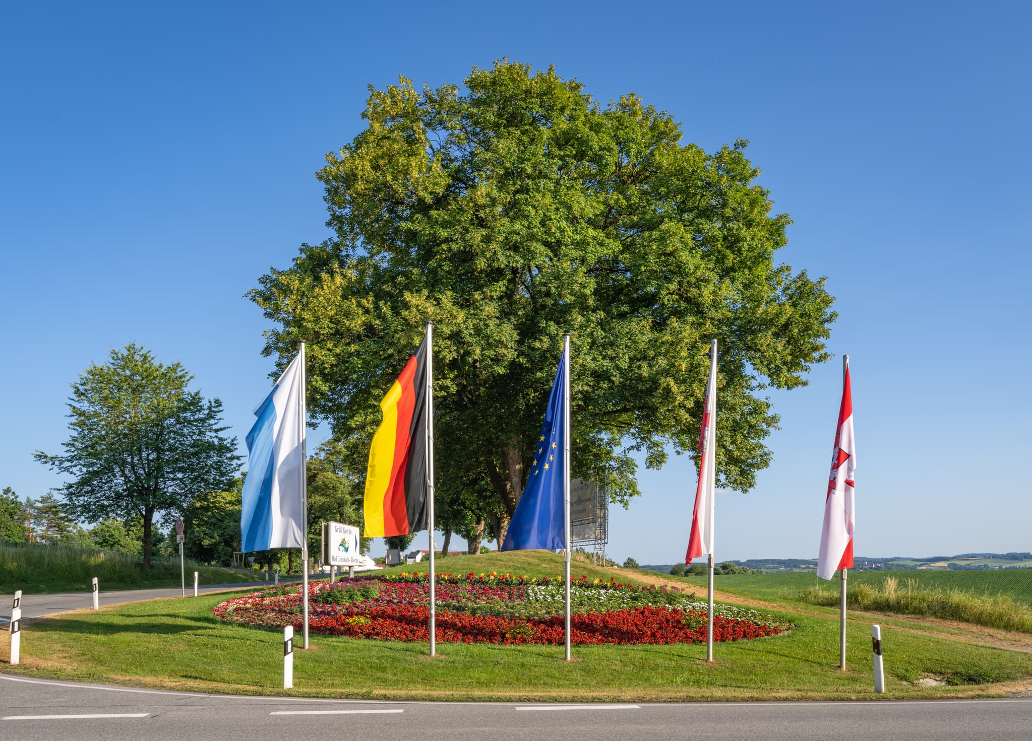 Einladende Therme Zufahrt Blumenbeet und Fahnen in Bad Griesbach, Landkreis Passau, Niederbayern, Deutschland. Eine Ansicht im Bäderdreieck.