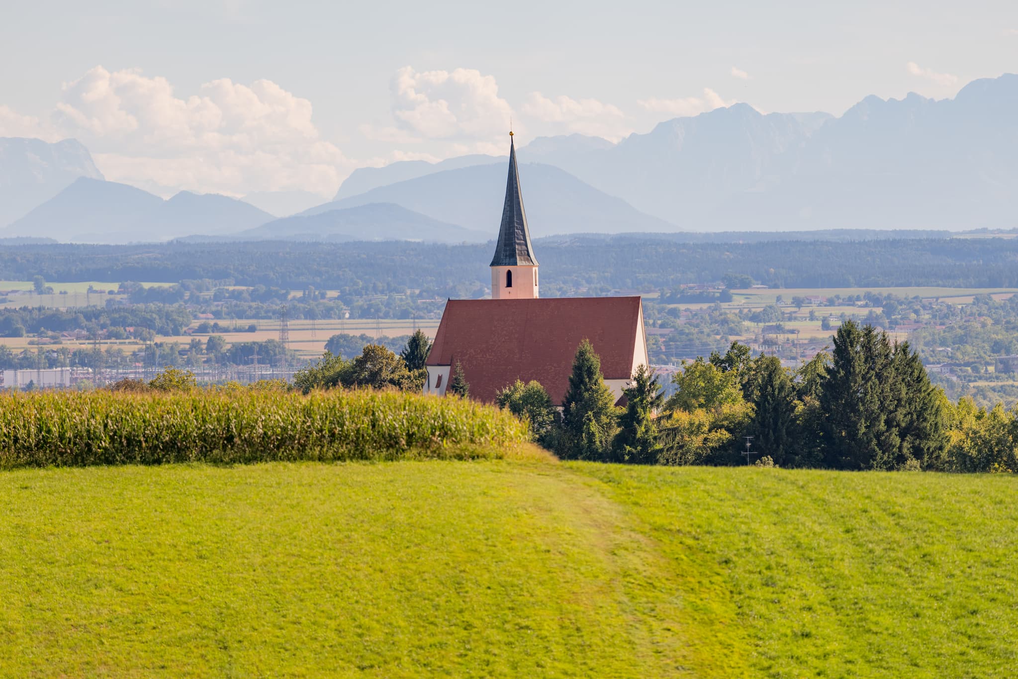Pfarrkirche St. Georg und Urban in Stubenberg, Rottal-Inn, Niederbayern. Kirche mit weitem Alpenblick und Bergpanorama, Holzland, Deutschland.