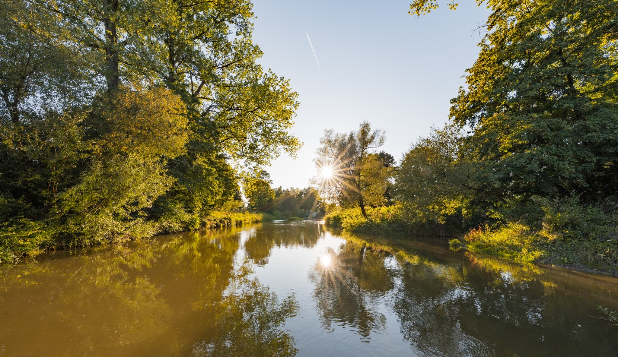 Flusslandschaft der Rott am Golfplatz Postmünster, Deutschland. Ruhiges Gewässer, grüne Ufer. Landkreis Rottal-Inn, Niederbayern, Region Bäderdreieck.