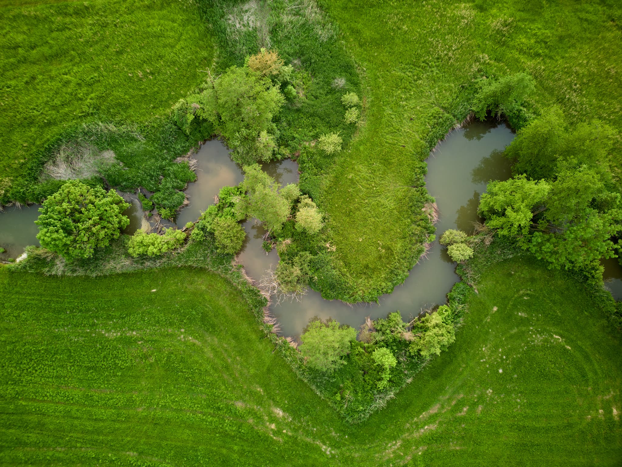 Luftbild des Hirschhorn Geratskirchner Bachs, schlängelt sich durch grüne Wiesen bei Wurmannsquick, Rottal-Inn, Niederbayern, Holzland, Deutschland.