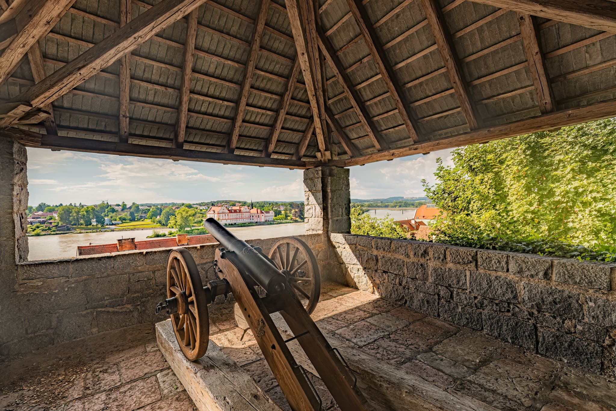 Blick vom Kanonenturm im Schlosspark Schärding, Oberösterreich. Historische Kanone überblickt den Fluss Inn in Schärding im Innviertel, Österreich.