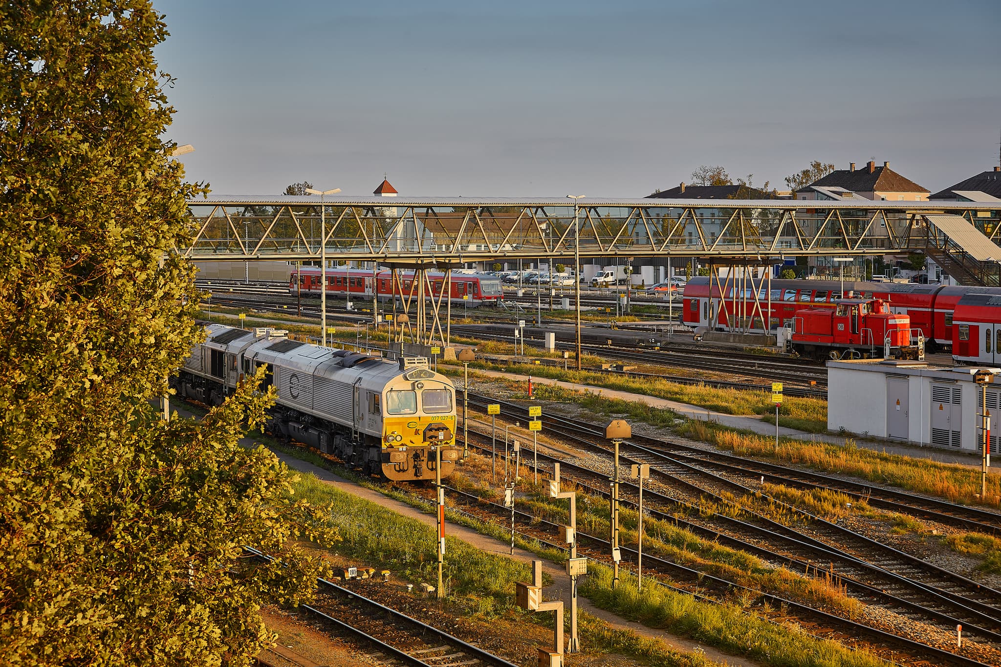 Der Bahnhof Mühldorf am Inn in Oberbayern, Deutschland, mit Gleisen, Zügen und Fußgängerübergang. Wichtiger Verkehrsknotenpunkt der Inn-Salzach Region.